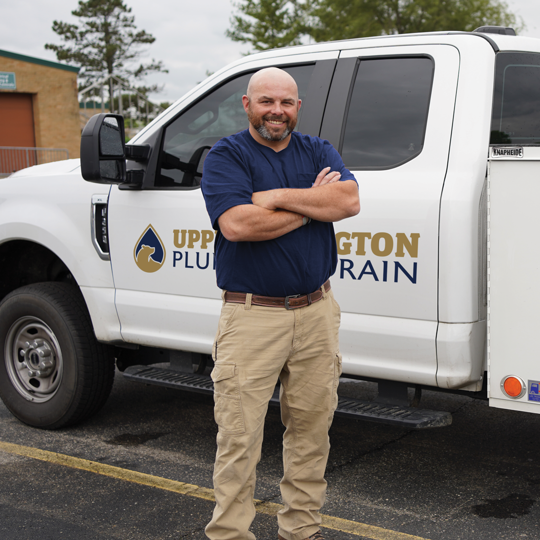 Plumber in front of truck